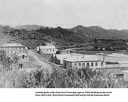 An historic black and white photo showing the Kūaotunu valley as seen from the Lower Township in circa 1900