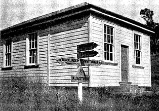 A black and white image of the Kūaotunu Hall in the early days, shortly after moving to its new site in the Kūaotunu village..