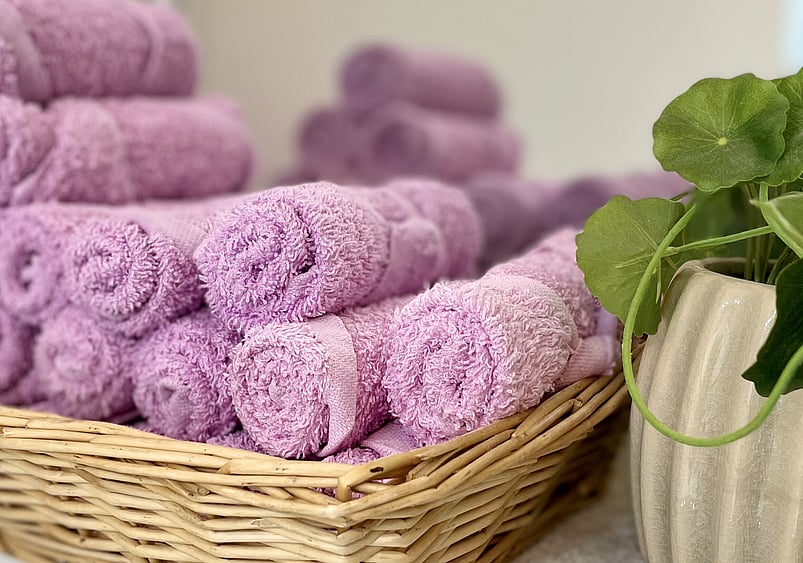 Image of rolled purple towels in basket Princess Nails Spa and Beauty