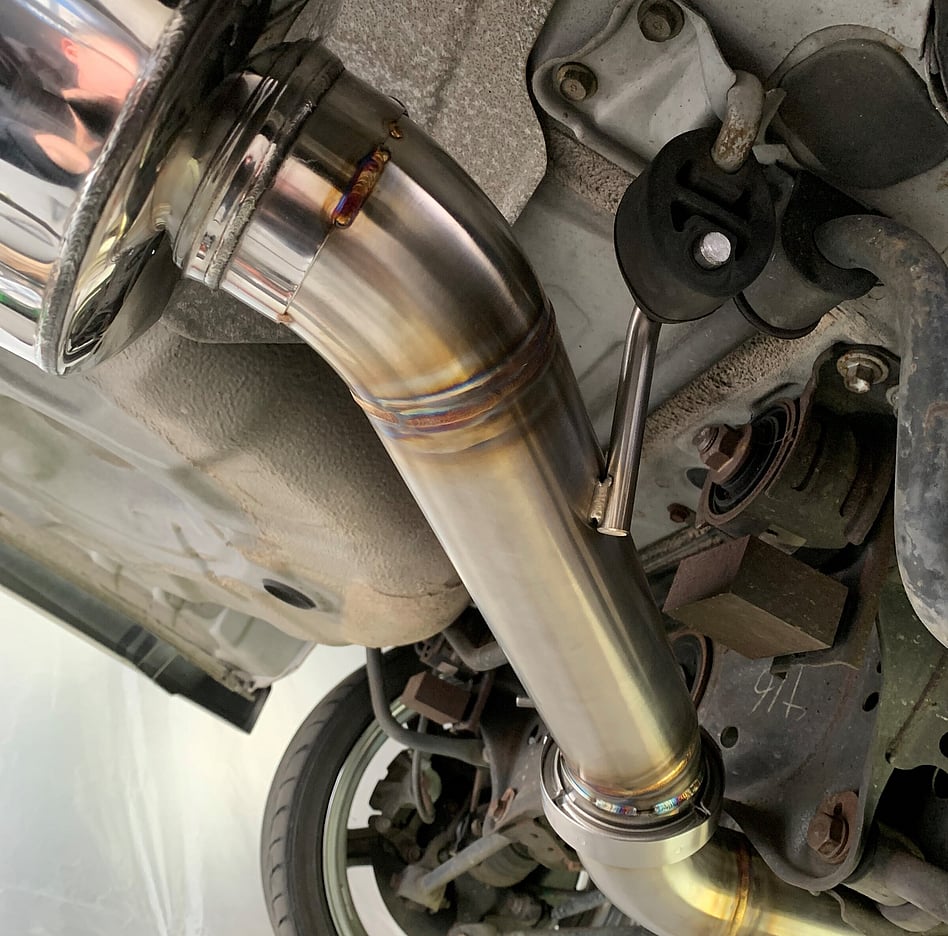 Stitch welds shown with the exhaust rod in the exhaust hanger