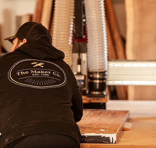 The Maker leaning on work bench