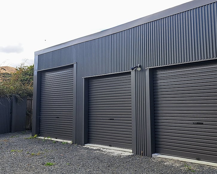 Dark exterior cladded triple door shed. Renovated by Coull Builders in Otorohanga.