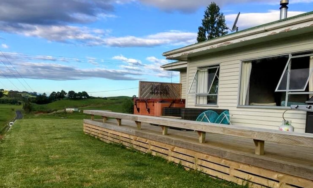 Image of weatherboard home and decking prior to its renovation by Coull Builders.