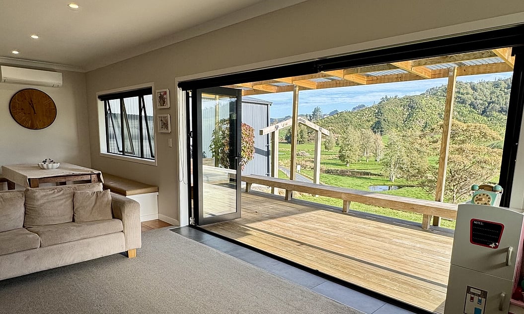 Fresh neutral space and deck with rural outlooks in renovated in Otorohanga home by Coull Builders, Waikato. 