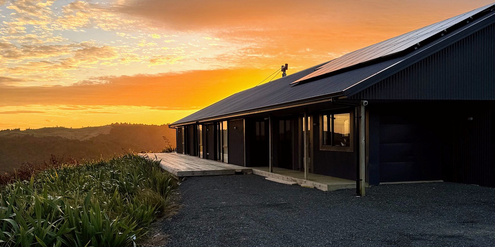 Image of dark exterior cladded new build home with Waikato rural outlooks. Built by Otorohanga builders, Coull Builders.