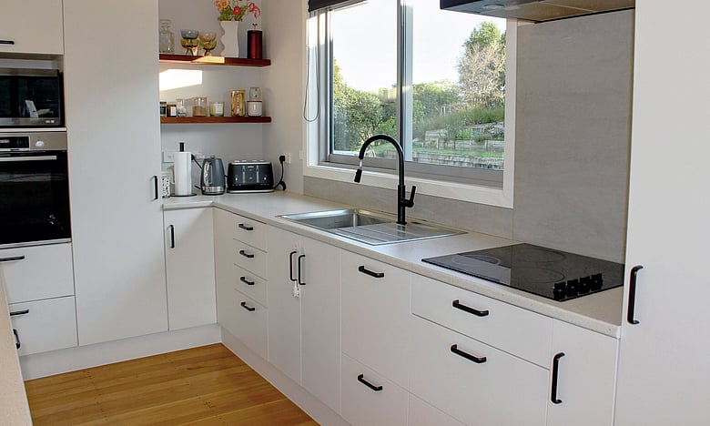 Image of light airy recently renovated kitchen in a weatherboard home. Renovated by Coull Builders, Otorohanga.