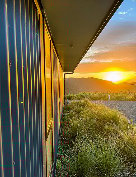 Close up image of dark exterior cladded new build home with Waikato rural outlooks. Built by Otorohanga builders, Coull Builders.