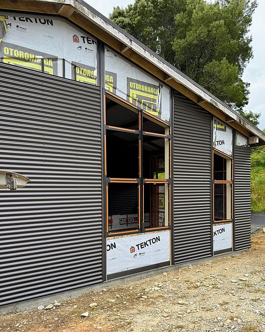 Dark exterior cladded office space in Waitomo by Coull Builders