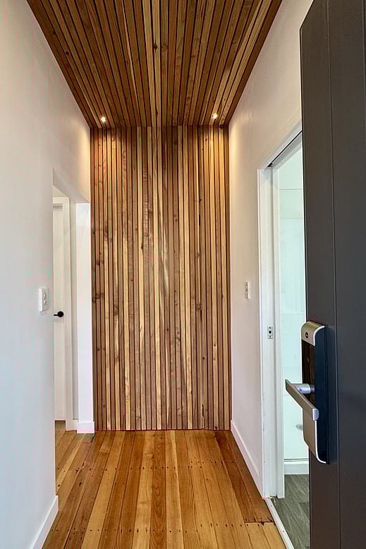 Close up of original and restored flooring and waterfall wall feature in recently renovated Otorohanga home by Coull Builders. Waikato.