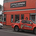 Orange truck with cool graphics outside Little Havana Whakatāne.  Cool as Cabins. Cabin hire Eastern Bay of Plenty.