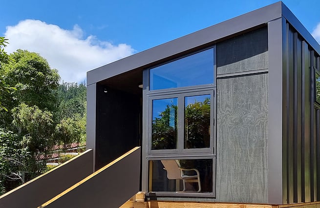 Front profile of a house with staircase leading up to front door
