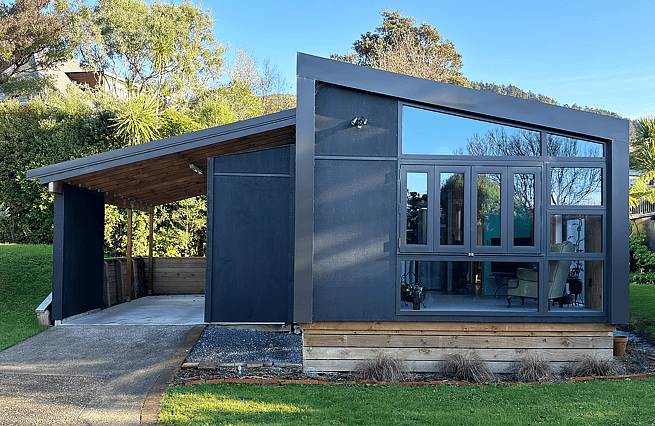 Assymmetric front of house with large windows and carport