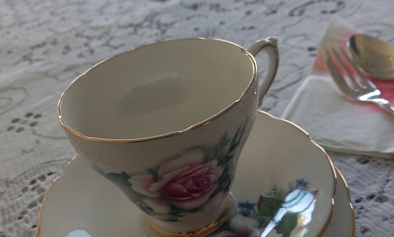 Tea cup, lace tablecloths at high tea party