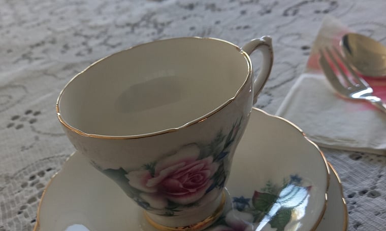 Tea cup, lace tablecloths at high tea party