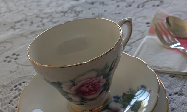 Tea cup, lace tablecloths at high tea party