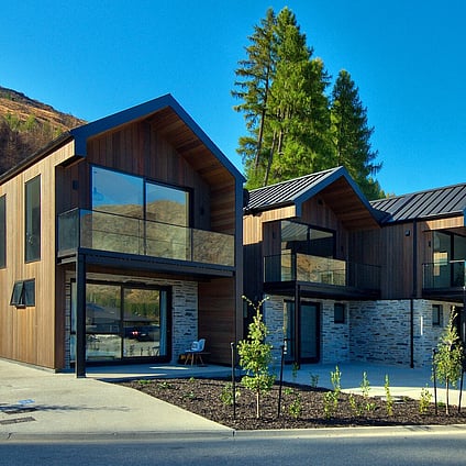 Timber and stone clad multi story apartments.