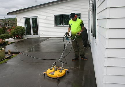 Photo of Aqua Force team member cleaning concrete at Hamilton property