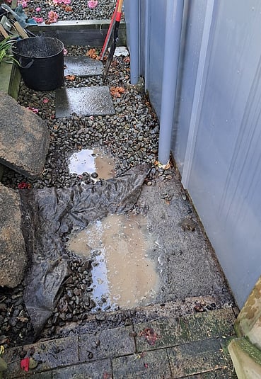 Water pooling by the side of a house