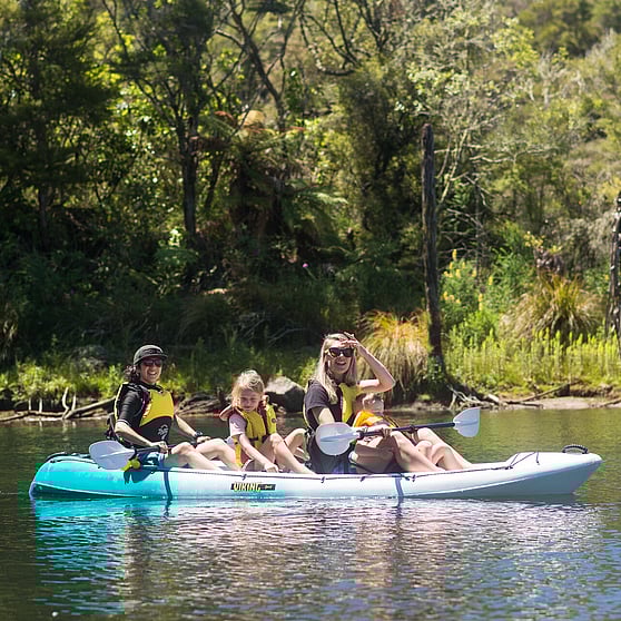 Family friendly activity in Rotorua, immersed in Waimangu Nature as they kayak to view the geothermal steaming cliffs