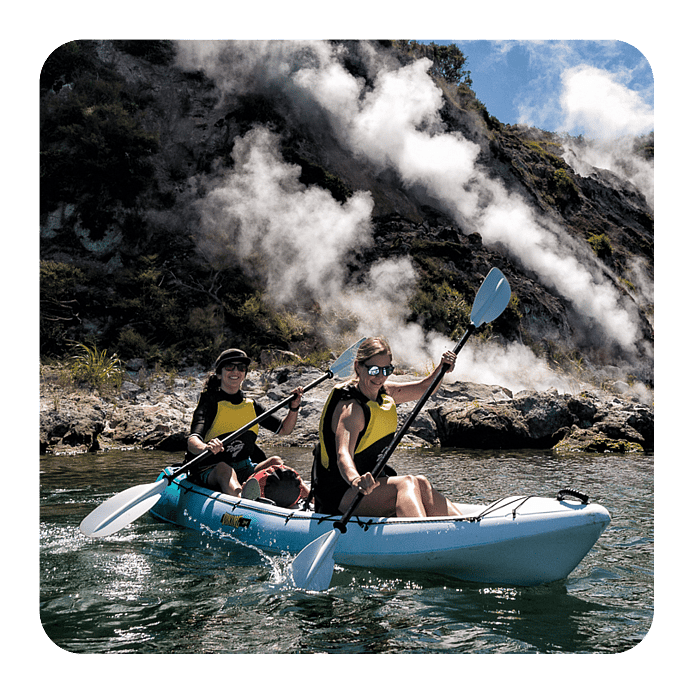 Waimangu Valley, Rotorua, kayaks on the water near cliffs