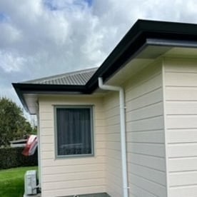 side view of a new installation of continuous spouting on Hamilton home