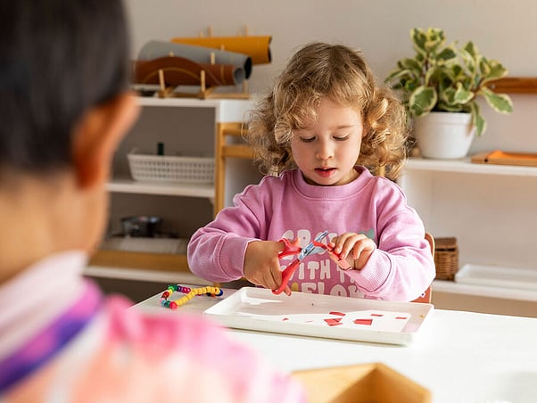 Child practising cutting shapes &ndash; Montessori practical life, Sunnynook