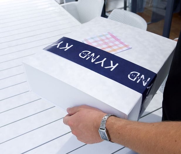 Holding a KYND Gift Box