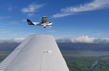 Cessna 172 ZK-EKE flies on the wingtip over the Southern Wairarapa