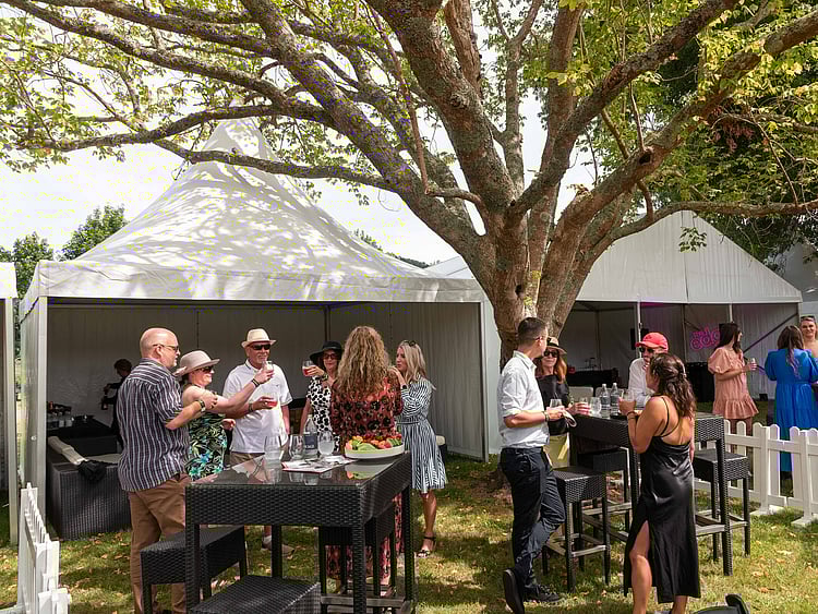 Full garden party setup with marquee, lounge area, umbrellas, and bar &ndash; private event marquee hire Auckland