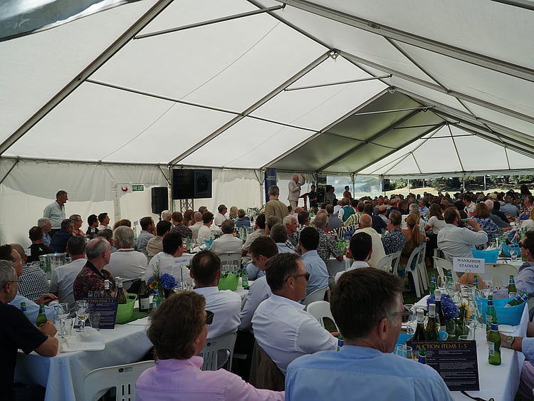 Team event in fully set up marquee with AV equipment, tables, and catering stations &ndash; Auckland corporate marquee packages