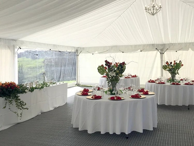 Round tables with white linen and floral centrepieces &ndash; wedding round table hire Auckland