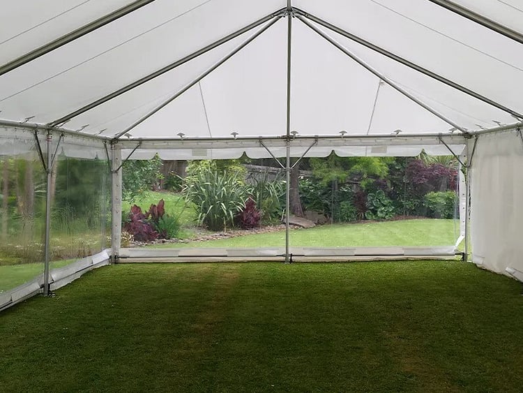 Empty white marquee on grass field &ndash; marquee only hire Auckland