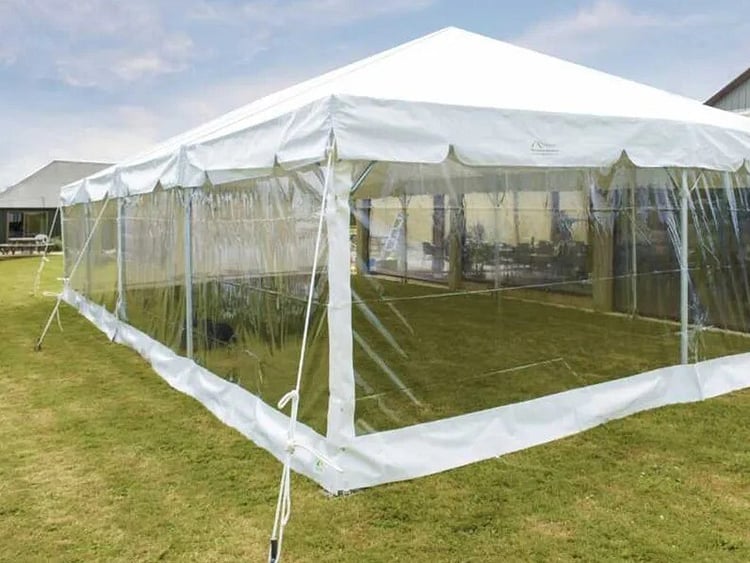Empty white marquee on grass field &ndash; marquee only hire Auckland