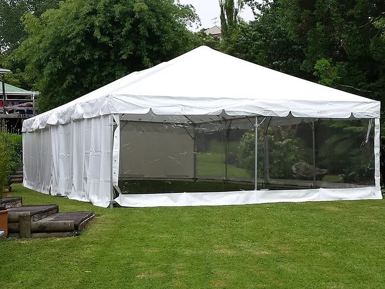 Empty white marquee on grass field &ndash; marquee only hire Auckland