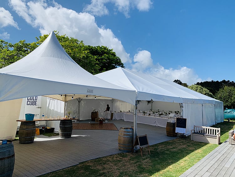 Team event in fully set up marquee with AV equipment, tables, and catering stations &ndash; Auckland corporate marquee packages