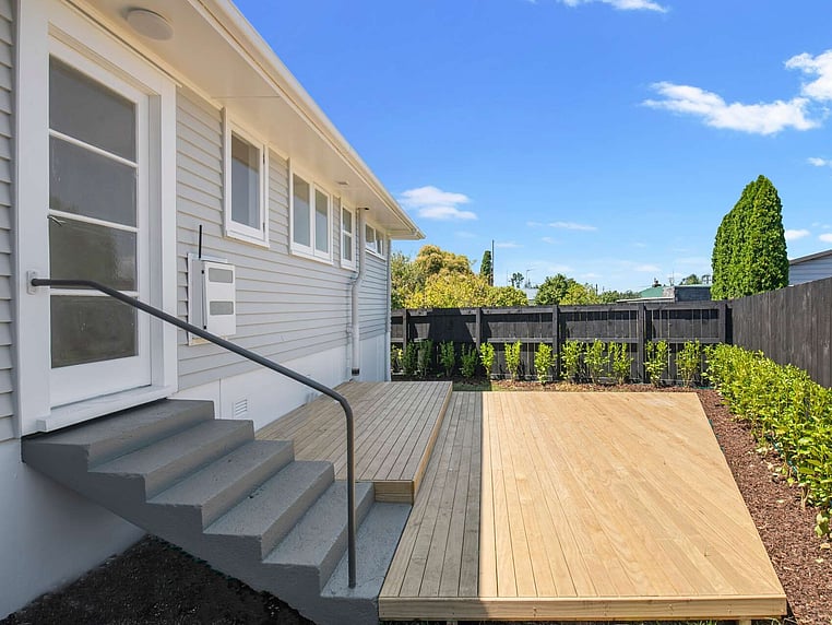 Image of a residential home renovation. Newly cladded, decked and landscaped by Auckland builders, Eden Construction. New Zealand.
