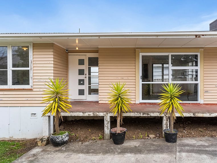  Image of a residential home renovation. Photo of exterior and landscape before renovation.
