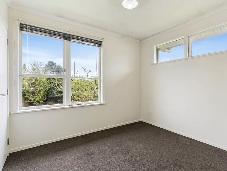 Image of a residential home renovation. Photo of bedroom before renovation.