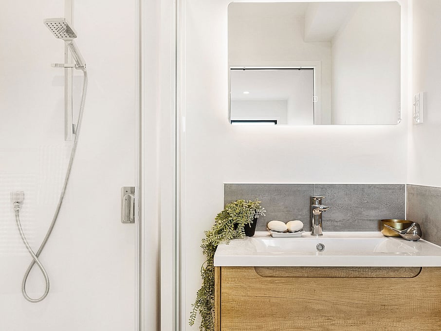 Image of the bathroom with single vanity inside the residential new build townhouses on Roland Hill, Glen Eden, Auckland. Built by Auckland builders, Eden Construction. New Zealand.