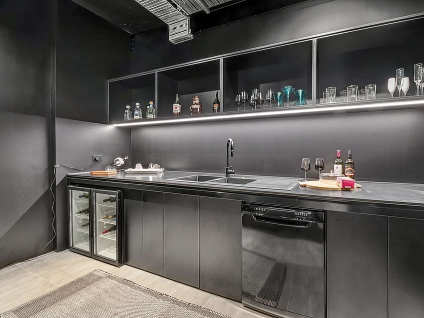 Image of a residential home renovation. Newly remodelled butlers kitchen in black by Auckland builders, Eden Construction. New Zealand.