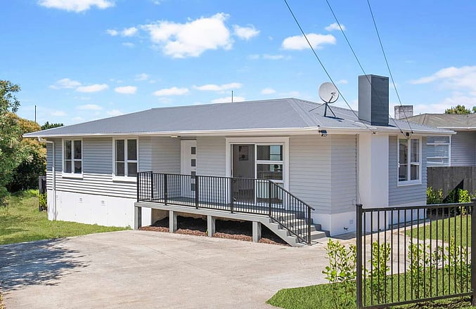 Image of a residential home renovation. Newly cladded, decking and landscaped by Auckland builders, Eden Construction. New Zealand.