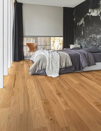 Natural oak timber flooring in a modern bedroom.