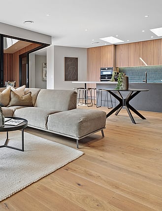 Oak flooring in an open plan kitchen and dining room.