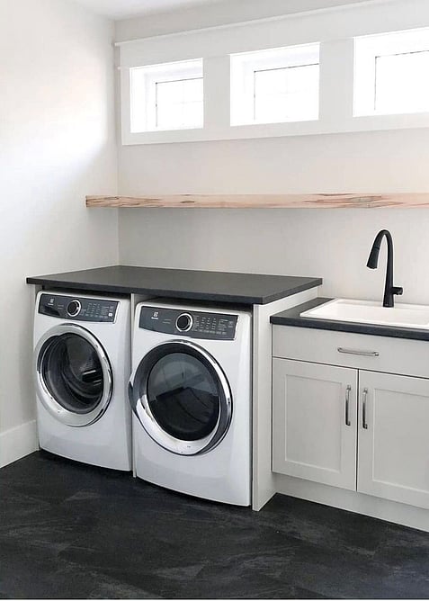 A black hybrid floor in a white laundry area.