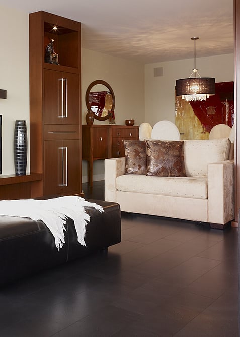A dark brown floor in a hotel suite lounge. 