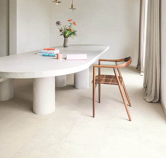 Light tile laminate floor with Oak chair and modern white table