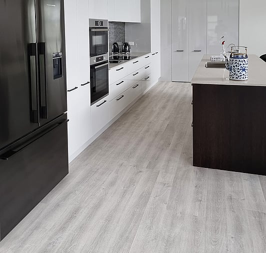 Grey Laminate Flooring in a Kitchen with white and black units
