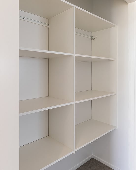 Wall hung shelving system in a hallway cupboard