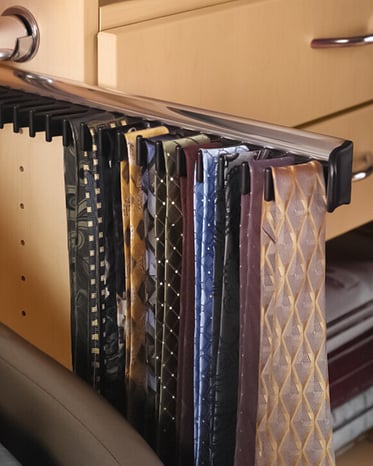Colourful ties handing on a tie rack.