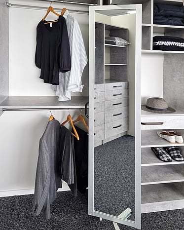 Grey wardrobe system with pull out wardrobe mirror.
